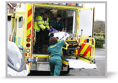 A picture of a paramedic holding two self-adhesive pads (as if about to shock somebody).