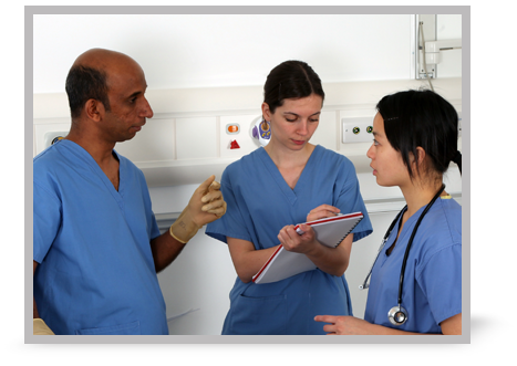 Three clinicians having a discussion and making notes.