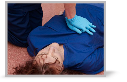 A clinician carrying out chest compressions on a woman.